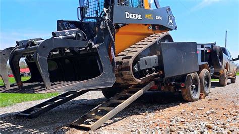 loading a skid steer on over the axle dump trailer|trailer skid steer loading.